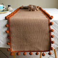 Jute Table Runner with Orange Pom-Poms, Boho Dining Table Decor — product view 1