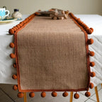 Jute Table Runner with Orange Pom-Poms, Boho Dining Table Decor — product view 1